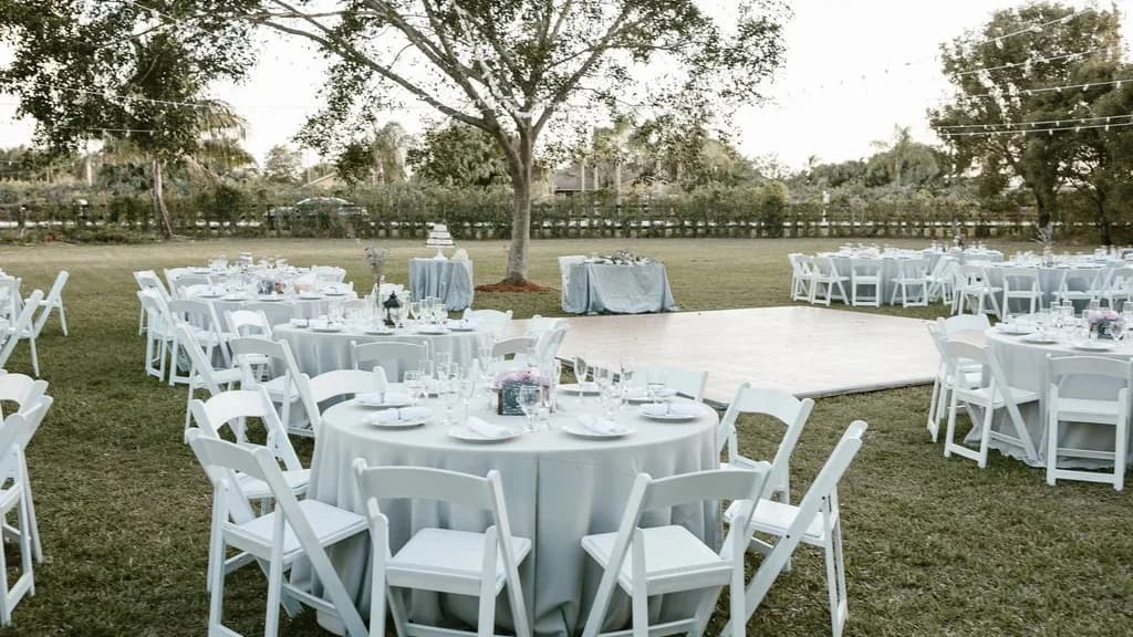 Round tables dressed with white covers for a reception